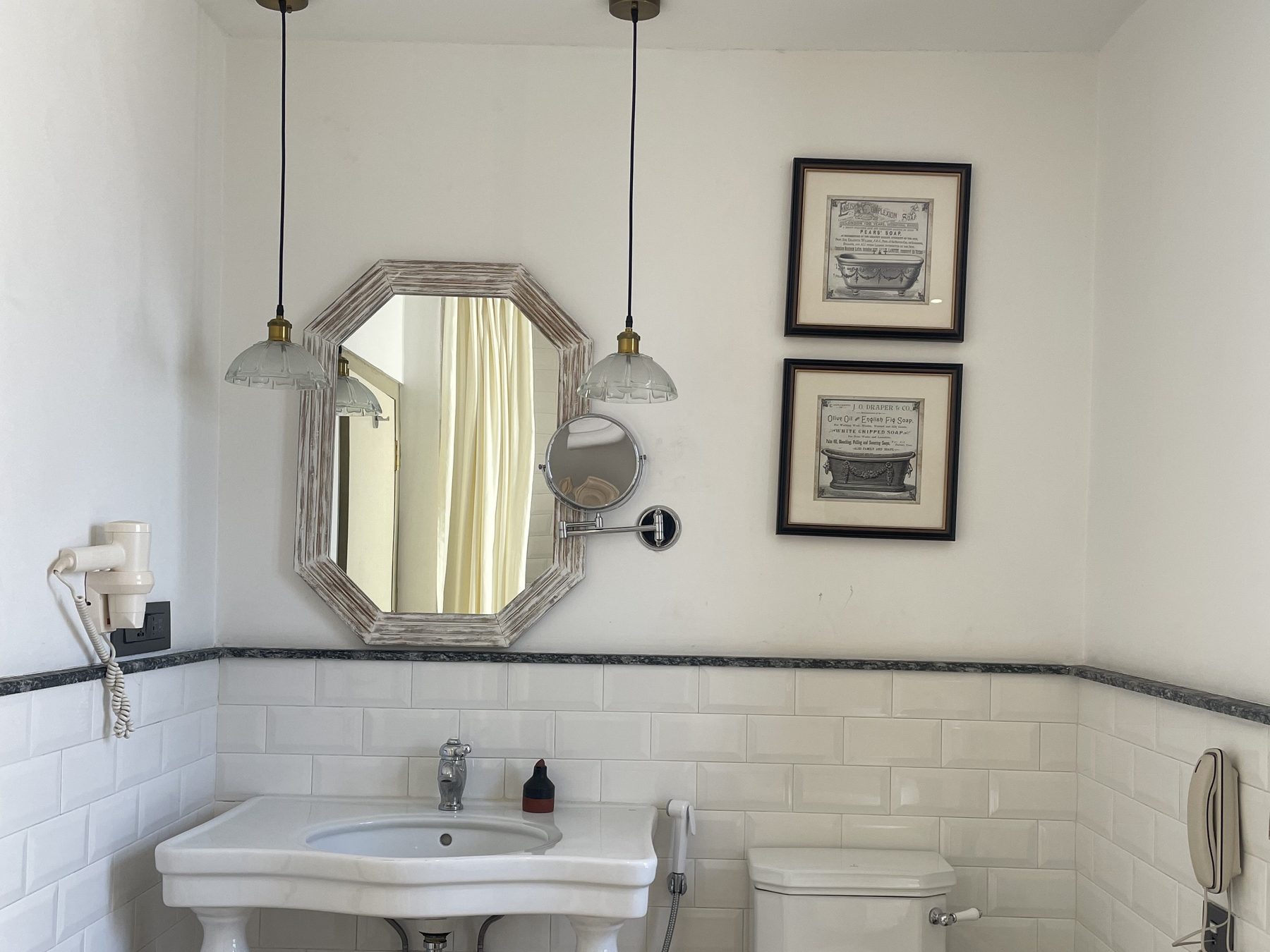 Classic Junior Suite bathroom vanity with marble washstand and octagonal mirror