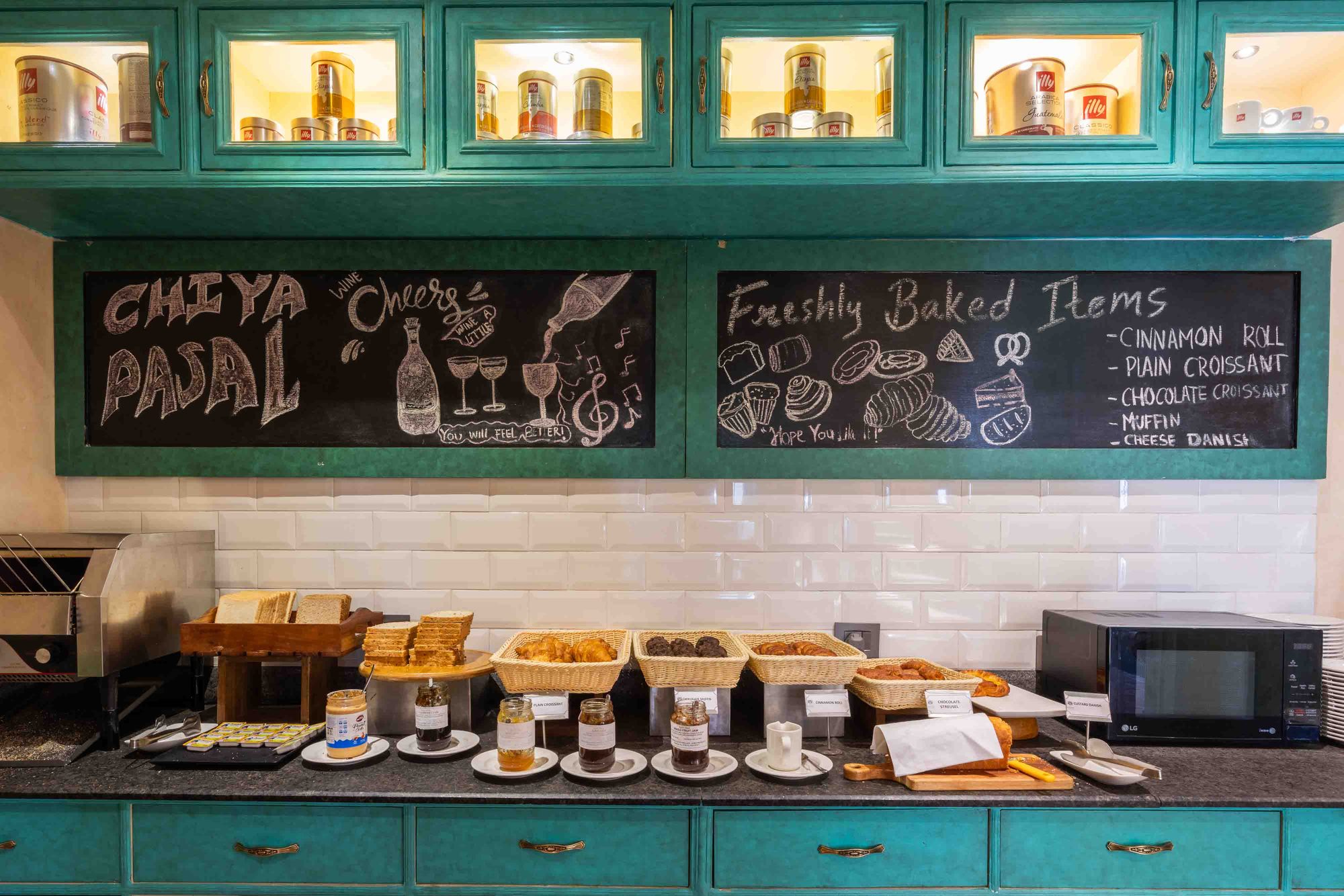 The Chiya Pasal counter, its hand-chalked board listing freshly baked items above the teal cabinetry