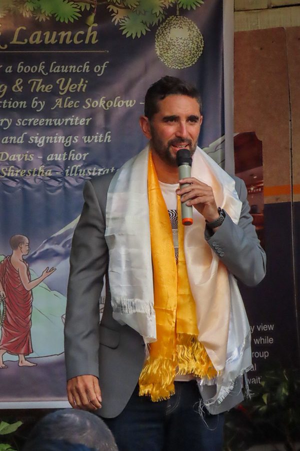 Alec Sokolow, draped in a khada, speaking at the Machig and the Yeti book launch